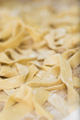 preparing homemade pasta for lasagna and tagliatelle, flour, eggs, water and salt.