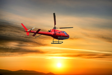 Fototapeta na wymiar Helicopter Flying at sunrise