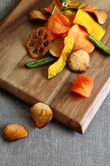 Fototapeta premium Dried Mixed Vegetable Chips on Wooden Board