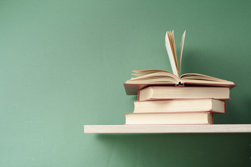 Open book, hardback books on wooden table. Education background. Back to school. Copy space for text.