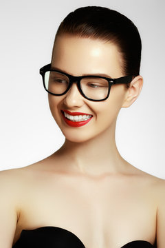 Excited woman looking sideways screaming of joy. Face expressions and people concept - portrait of smiling fashion model glasses. Fashion and accessories