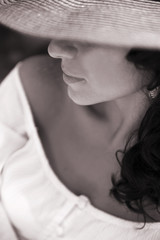 portrait of beautiful brunette woman in a straw hat