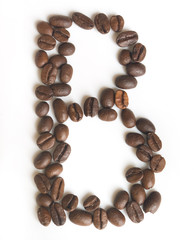 Letter B made of coffee beans under a daylight isolated on white background