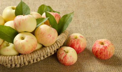 Naklejka na ściany i meble ripe apples in a beautiful wicker basket