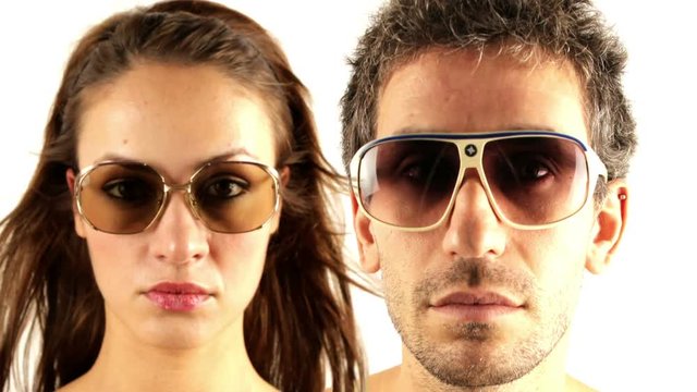 man and woman wearing different retro sunglasses