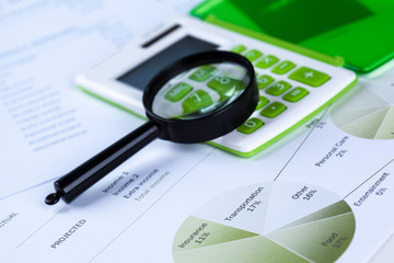 Calculator and magnifying glass on the table