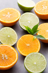 Mixed citrus fruit lemons, orange, kiwi, limes on a gray backgro