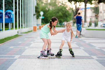 two beautiful little sisters in a roller skates