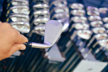 Closeup view of person holding in hand golf club during shoping.
