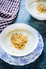  Healthy breakfast :oatmeal flakes in the bowl on blue background.