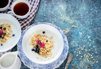 Healthy breakfast :oatmeal flakes with berries and tea/coffee.