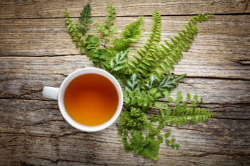 Cup of tea with fern leaf