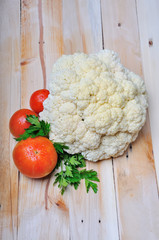 Fresh cabbage and tomato on wood background