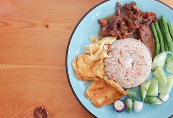 Rice mixed with Shrimp Paste. Thai food on wooden background.
