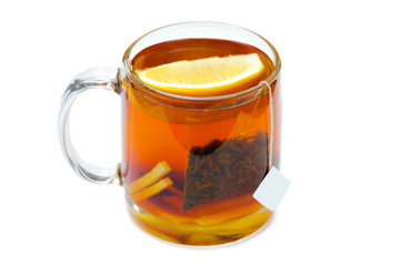 Black tea with a slice of lemon in a glass mug