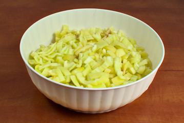 Chopped paprika in a white plastic bowl