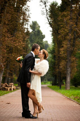 Fototapeta premium Groom kisses a bride with hair put in plait