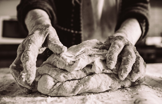 old  italian lady's hands making home made italian pasta