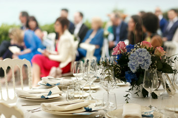 Look from the rich served white dinner table standing before the