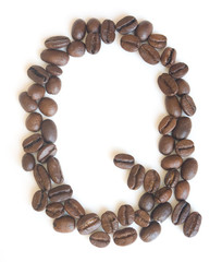 Letter Q made of coffee beans under a daylight isolated on white background