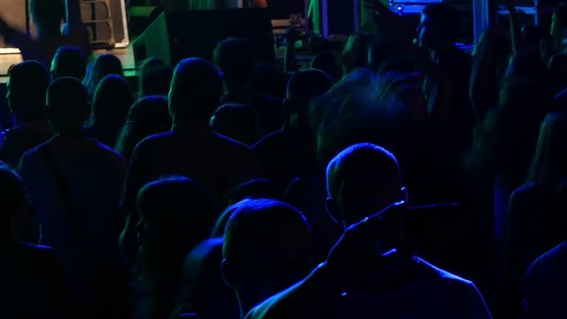 UKRAINE, VINNITSA - AUGUST 10, 2016: people crowd dance in concert lights