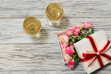 Two glasses of white wine and flowers