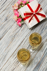 Two glasses of white wine and flowers