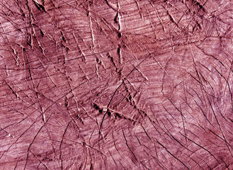 Abstract pink toned  cut old tree surface with axe scratches.