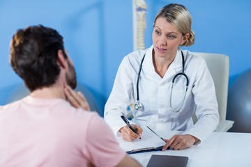 Physiotherapist interacting with patient