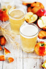 
summer and autumn cooling drink , white brew or kvass with honey , apples , raisins and bread on wooden background