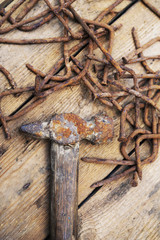 Old rusty tools, the hammer and nails on an old wooden background of a table