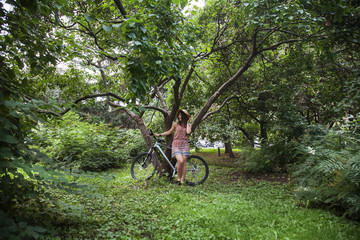 Fototapeta na wymiar girl standing with a bicycle