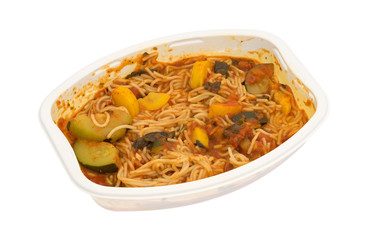 Angel hair pasta with zucchini and spinach side view on a white background.