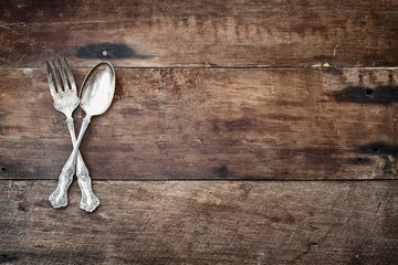 Antique Silverware over Wooden Background