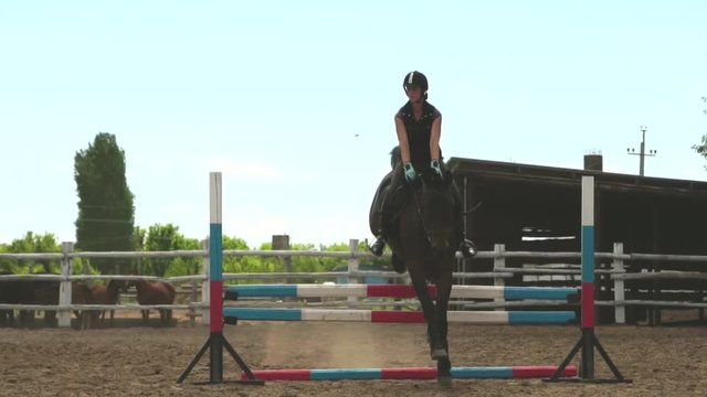 Horse woman jumps through the barrier on horseback slow motion HD