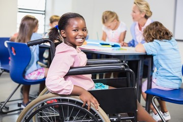 Fototapeta na wymiar Disabled schoolgirl smiling in classroom