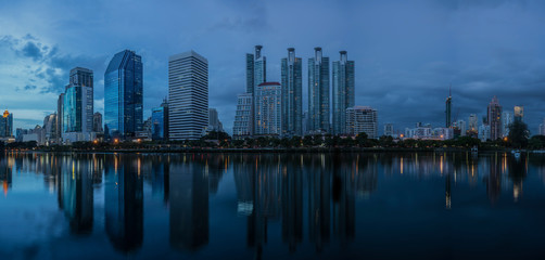 Panorama of Benchakitti park , green lung of Bangkok , in blue hour with reflection , Thailand