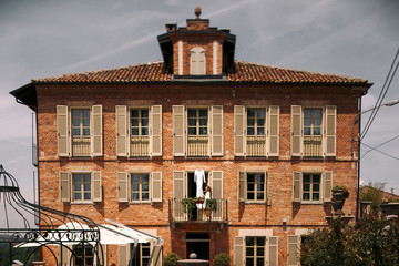 Woman stands before a wedding gown hanging on the balcony