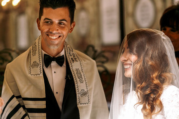 Jewish wedding. Beautiful bride looks at a groom - obrazy, fototapety, plakaty