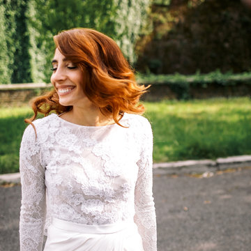 Picture of a smiling woman whirling her red hair