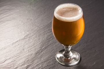 Glass beer on stone background with copy space. wallpaper