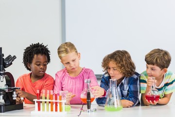 Kids doing a chemical experiment in laboratory