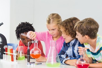 Kids doing a chemical experiment in laboratory
