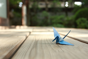 Paper crane resting on wooden veranda of Japanese traditional house