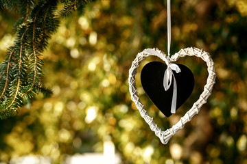 Black heart put into the white heart hang from the tree
