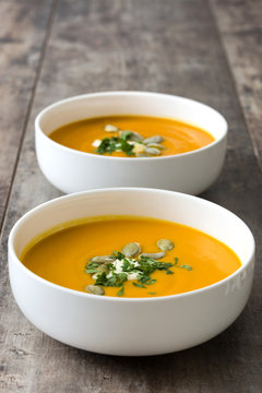 Pumpkin soup in bowl and pumpkin seeds

