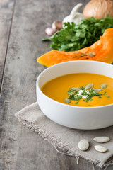 Pumpkin soup in bowl and pumpkin seeds
