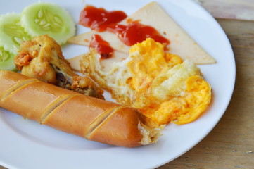 deep fried egg and sausage dressing ketchup on plate