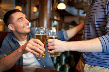 happy male friends drinking beer at bar or pub