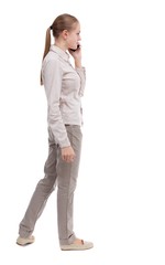 back view of a woman talking on the phone.  backside view of person.  Rear view people collection. Isolated over white background. A girl in a white jacket is thoughtfully speaking on the white phone.